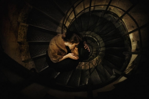 A kiss in the spiral staircase of the Arc de Triomphe.